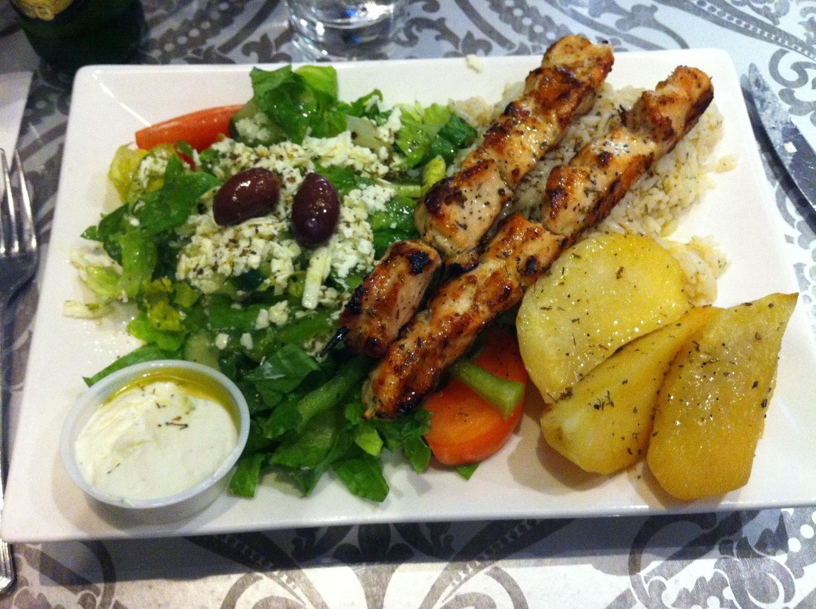 Chicken souvlaki plate with Greek salad, lemon potatoes and tzatziki